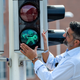 Aarhus city council member Bunyamin Simsek replaces the first of the many pedestrian signals with Vikings lights on Aug. 26, in Aarhus, Denmark.